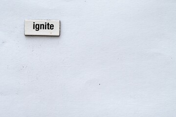 The word "ignite" on a white background wrote with fridge magnet