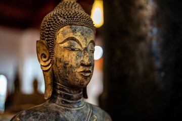 Ancient Buddha statue at Wat Visoun in Luang Prabang, Laos, Southeast Asia