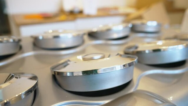 A row of metal ice cream containers with closed lids - Ice cream freezing concept. High quality 4k footage