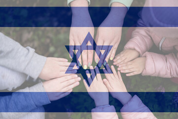 Hands of kids on background of Israel flag. Israeli patriotism and unity concept.