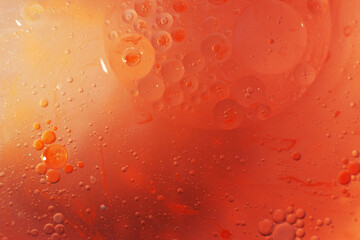 Gold and red Oil bubbles close up. circles of orange and pink water macro. abstract shiny background