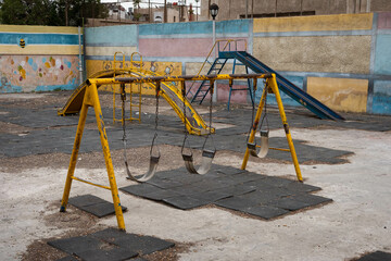 run down swing on old children`s  playground