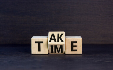 Take your time symbol. Concept word Take Time on wooden cubes. Beautiful black table black background. Business and Take your time concept. Copy space.