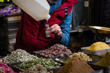 Vendor at spice , herb, perfume and oil store in souq, Damascus, Syria
