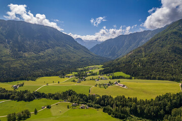 Fototapeta na wymiar Aerial view of the village, fields and forest in mountains Alps Austria