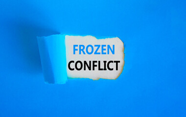 Frozen conflict symbol. Concept words Frozen conflict on beautiful white paper. Beautiful blue table blue background. Business and Frozen conflict concept. Copy space.