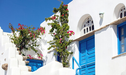 Tinos island Greece. Cycladic architecture at Volax village. Marble lintels, pink bougainvillea,