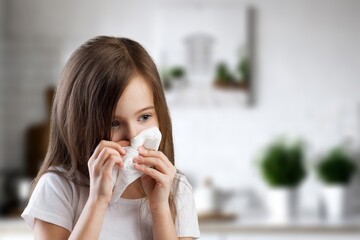 Sad small child hold tissue sneeze