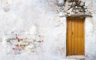 Home entrance door with on white wall, copy space. Cycladic architecture at Greece.