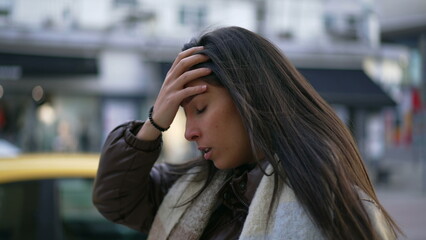 One anxious Middle Eastern young woman walking in street feeling frustrated. Female person in 20s suffering from mental pressure in urban environment sidewalk © Marco
