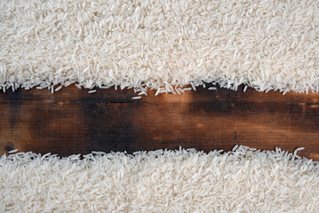 white rice natural long rice grain on wooden table use texture background