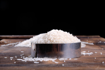 white rice natural long rice grain on wooden table use texture background