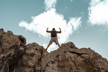 Man on a mountain feeling strong and motivated 