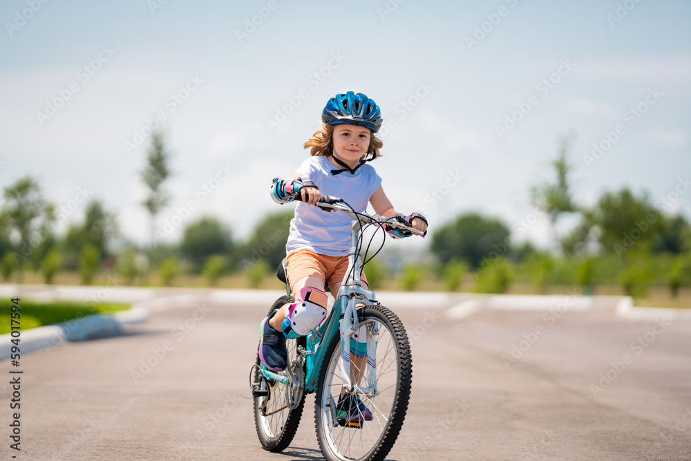 Canvas Prints Child in safety helmet riding bike. Boy riding bike wearing a helmet outside. Child in safety helmet riding bike. Little kid boy learns to ride a bike. Kid on bicycle. Happy child in helmet riding a