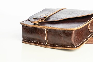 Closeup of a dark brown leather bag for men isolated on a white background