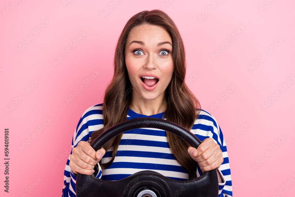 Sticker Photo of surprised funny young girl brown curls drive her new fast car unexpected how cool this purchase isolated on pink color background