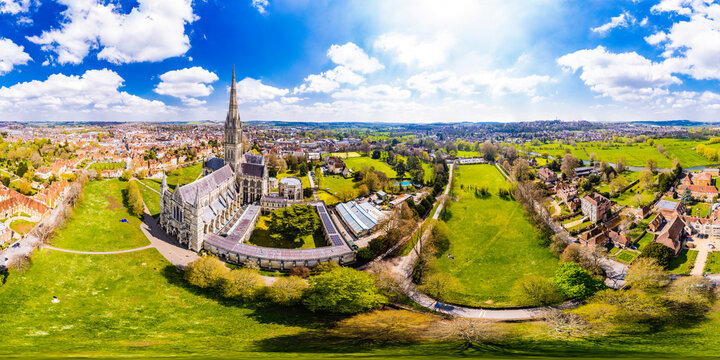 High aerial panorama view of Salisbury Cathedral and surroundings as a 360 VR equirectangular point of view, sunny blue sky with fluffy clouds.