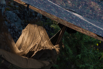 Sun shining through a mosquito net on a hammock