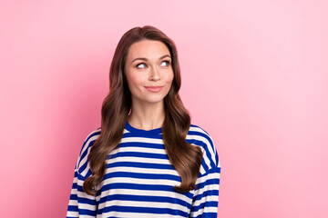 Fototapeta na wymiar Portrait of good mood girlish person with curly hairstyle wear striped clothes look at offer empty space isolated on pink color background