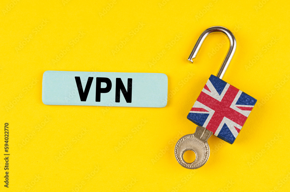 Poster on the yellow surface is an open lock with a key and a sticker with the inscription - vpn