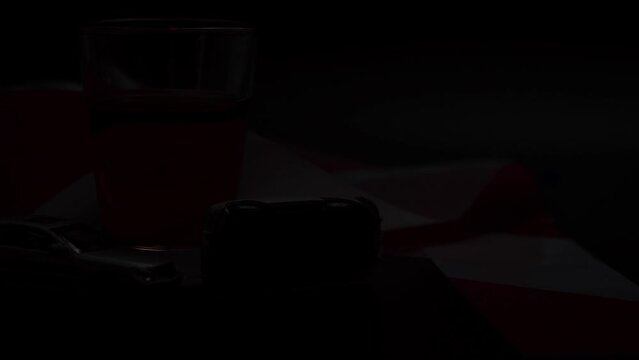 Mini car accident. Alcohol and a toy car on a dark background. Drunk driving warning.