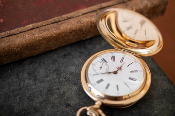 vintage gold pocket watch longines isolated on white background