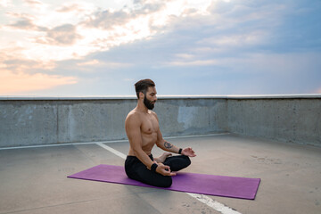 Fototapeta premium attractive hansome man with athletic strong body doing morning yoga dzen meditation