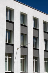 The windows of the white three-story building