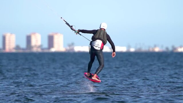 Sportsman fall practicing hydrofiol kite surf. Hydrofoil kite surfer fail at the Spanish seashore.