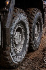 Fototapeta na wymiar Dirty truck wheels close-up photo.