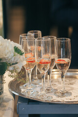 silver tray of flutes with champagne and strawberry slices at wedding