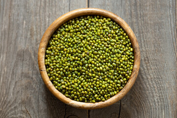 Bowl of fresh mung beans (Vigna radiata) on an old wooden table