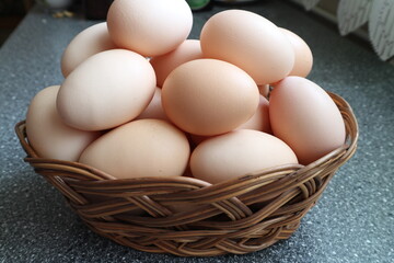Eggs are placed in a wicker bowl. A wicker bowl full of eggs. eggs in a basket.