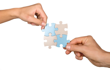 Closeup on Hands Combining Puzzle Pieces Together