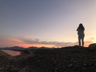 silhouette of person standing on top of mountain