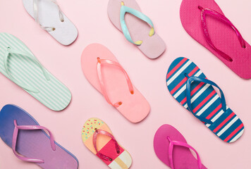Many bright flip flops on color background, top view