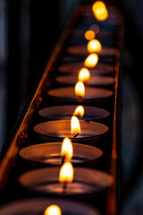 Candles igniting in dark church