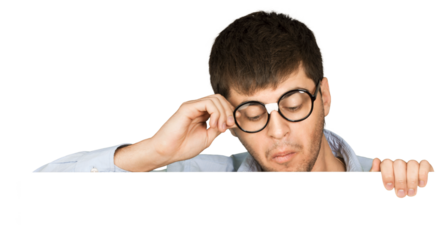 Man in taped up glasses looking down at a blank sign or board