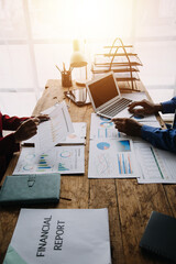 Financial analysts analyze business financial reports on a digital tablet planning investment project during a discussion at a meeting of corporate showing the results of their successful teamwork.