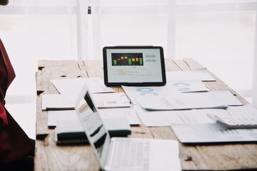 Fototapeta premium Financial analysts analyze business financial reports on a digital tablet planning investment project during a discussion at a meeting of corporate showing the results of their successful teamwork.