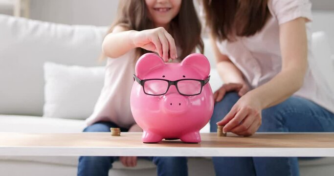 Mother And Child Saving Money