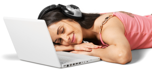 Young woman lying down in front of her laptop with headphones on