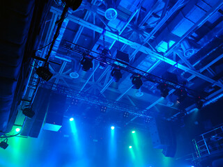Professional lighting equipment on the stage ceiling on a blue background