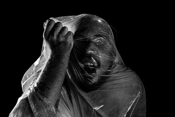 Man with plastic bag over his head, suffocated. Black and white shot.