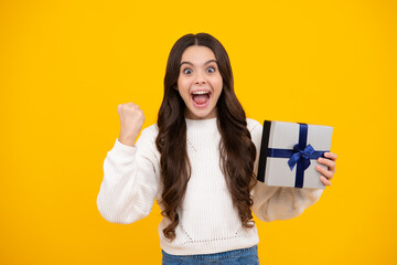 Excited teenager girl. Teenager child with gift box. Present for holidays. Happy birthday, Valentines day, New Year or Christmas. Kid hold present box.