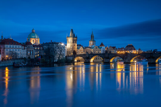 Evening view of Prague's Old Town and Charles Bridge from the river level after sunset