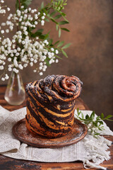 Yeast dough Cruffin bun with poppy seed and succades filling. Rolled up brioche, Easter baking.