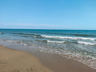 Fototapeta na wymiar beach and sea, calm vacation day at the seaside, blue sky view on the sea