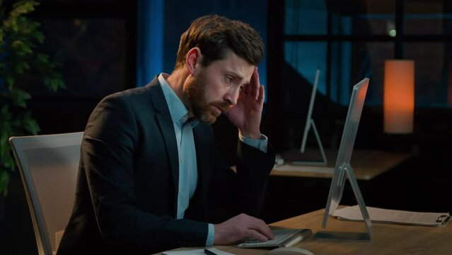 Night office businessman working computer late overwork tired exhausted sick middle-aged Caucasian man relieving eye strain blurry vision rubbing irritated eyes feel headache problem stress fatigue 