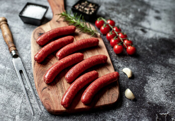 raw beef sausages on stone background